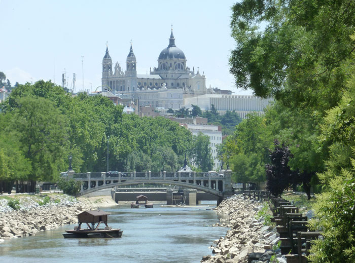 River Manzanares in Madrid (Spain). Centre: Queen Victoria Bridge. Background: Almudena Cathedral.